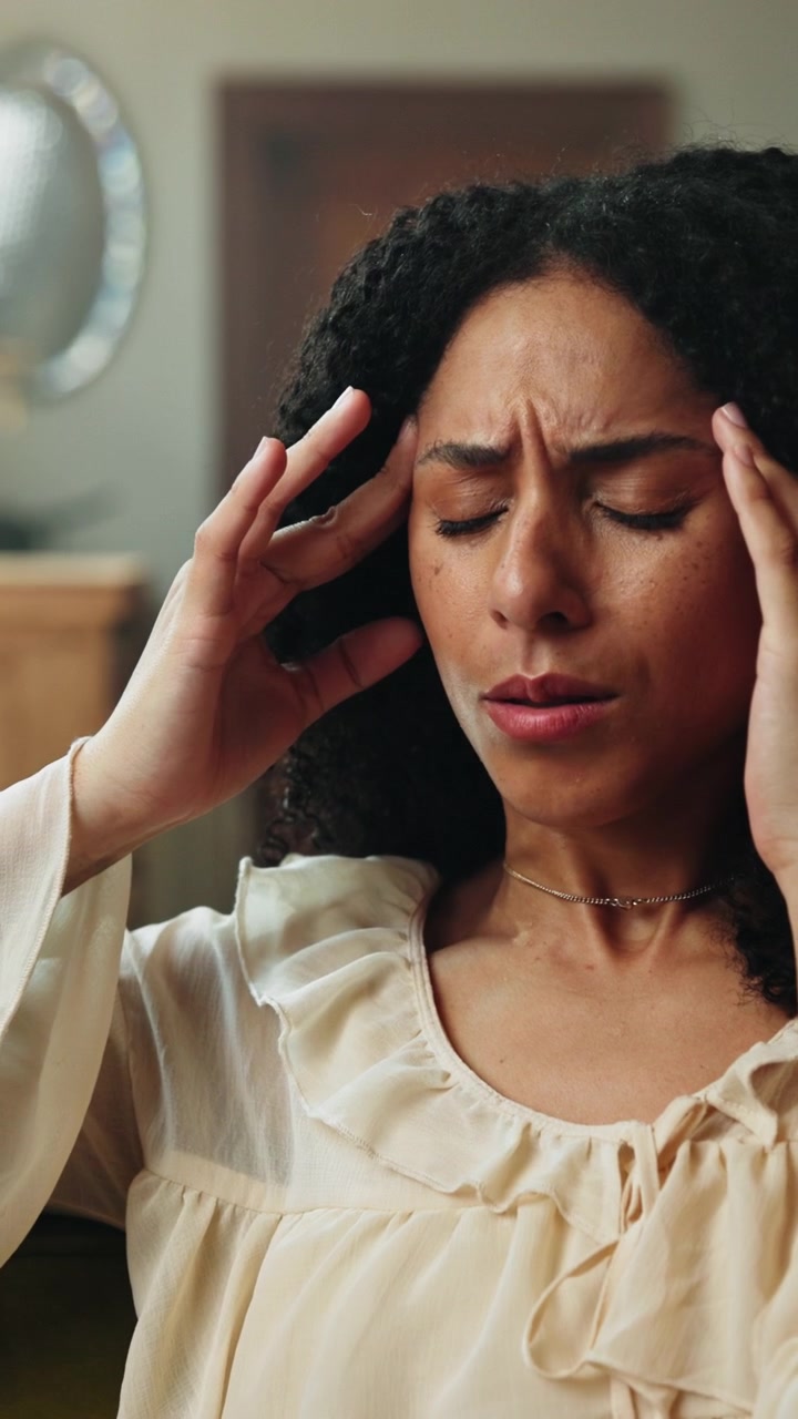 Young Woman Suffering From a Migraine or Headache