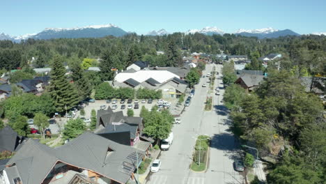 AERIAL---Beautiful-wooded-city-of-Villa-La-Angostura,-Neuquen,-Argentina,-pan-right