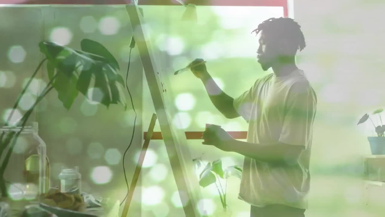 아프리카계 미국인 남성 의 애니메이션 은 밝은 반점 위 에 그림 을 그린다