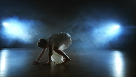 Slow-motion:-female-dancer-on-stage-in-smoke.-Modern-ballet-barefoot-on-stage.