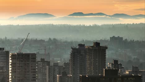 west end vancouver skyline and mystic landscape in fog at sunset in british columbia, canada