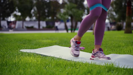 woman exercising with resistance band in a park