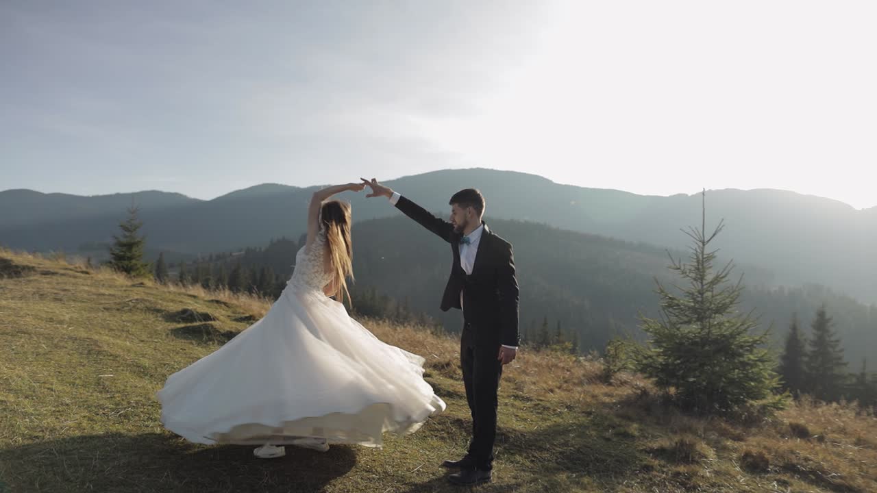 Yeni evliler. Kafkas damat ve gelin dağ yamacında dans ediyor. Düğün çifti.