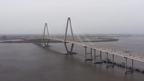 aerial close-up panning shot of ravenel bridge from patriot's point on a gloomy afternoon in mount pleasant, south carolina