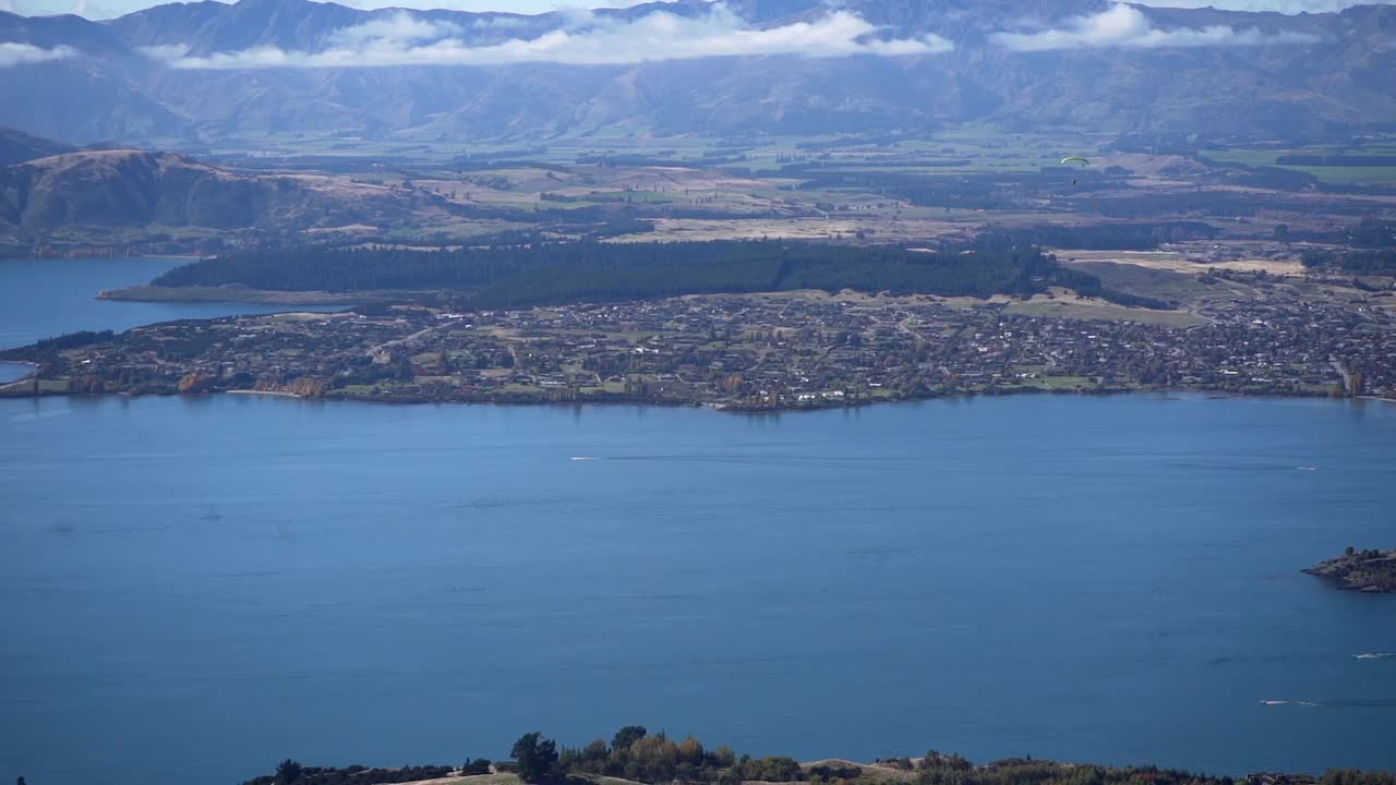 Aerial view of a lake with mountains and a town