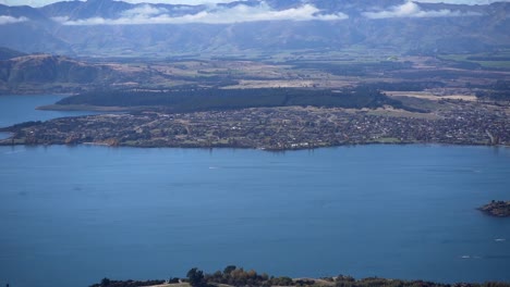 aerial view of a lake with mountains and a town