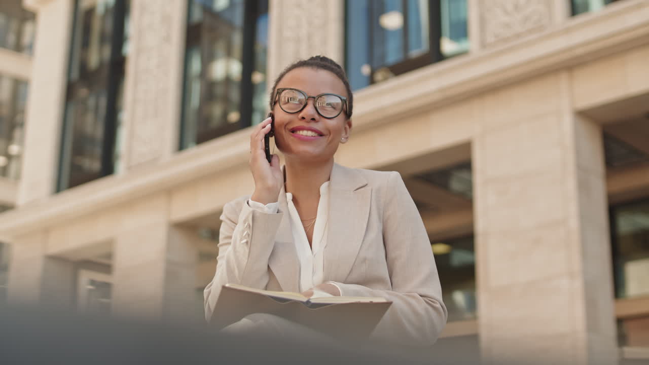 Smiling Businesswoman Making Phone Call Outdoors
