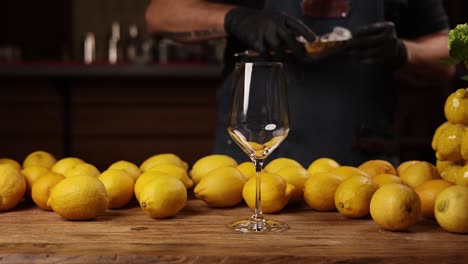 bartender making a cocktail with lemons