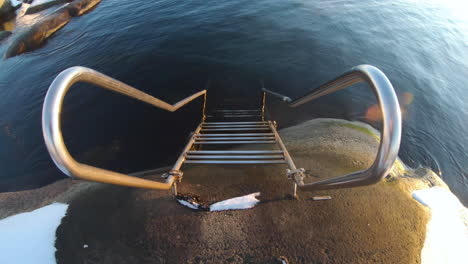 4k close-up of a metal staircase by the very cold ocean water at gothenburg, sweden