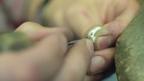 close ups of a craftsman making jewellery in a workshop