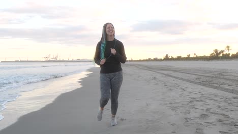 woman with braids running on the seashore