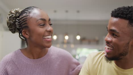 Happy-african-american-couple-talking-to-camera-during-video-call