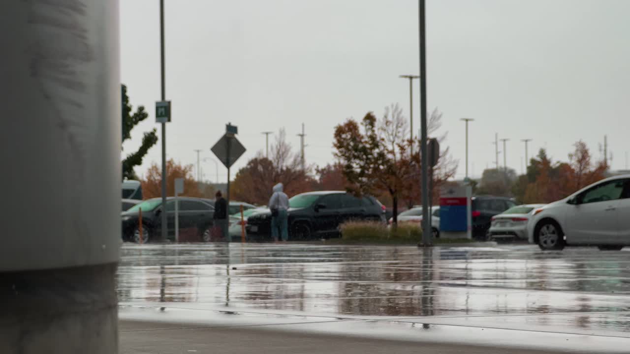 A serene parking lot scene after rainfall, with wet pavement mirroring colorful autumn foliage and vehicles. A peaceful moment capturing the interplay of rain and light.