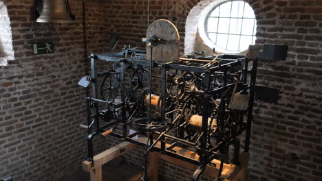 Close-up-tilt-down-of-historic-clock-mechanism-on-display