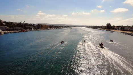 Rowing-crew-regatta-race-in-early-morning-at-Newport-Beach,-California,-aerial-drone-tracking-three-boats-in-race