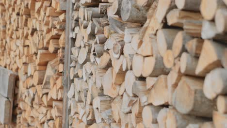 smooth camera dolly movement of a stack of piled wood lumber outdoors