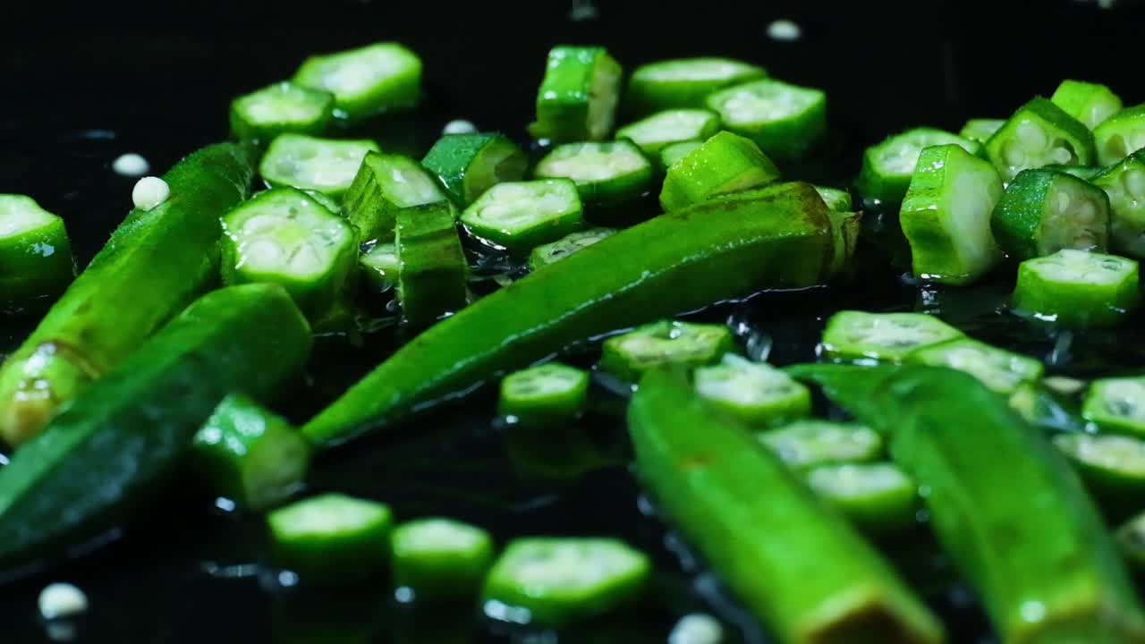 Drops of water falling on okra, or lady's fingers on a wet surface