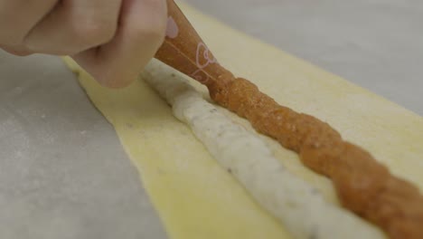 layering down meat sauce onto lasagna dough