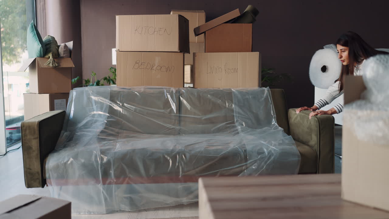 Woman moving boxes in new apartment