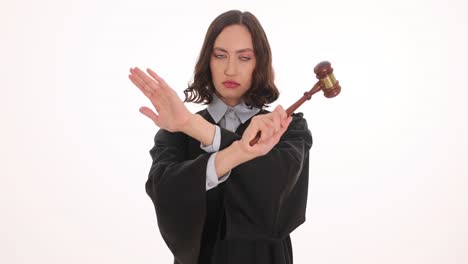female judge making stop gesture with gavel
