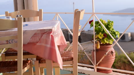 a table in a greek restaurant, with sea views, on the island of santorini, greece