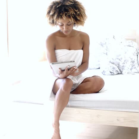 Young-Woman-Using-Tablet-On-Bed