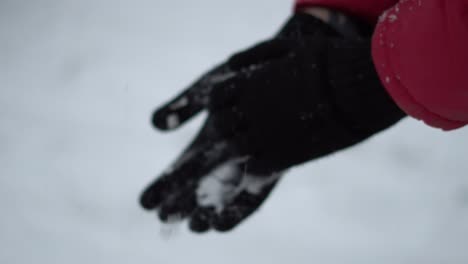 Close-up-man-cleaning-his-gloves-from-snow