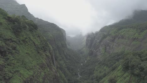 A-cinematic-aerial-drone-view-of-a-lush-green-rain-forest-on-the-hills-of-western-ghats-in-Andharban-forest-of-Pimpir-region-in-Maharashtra,-a-popular-trekking-destination-for-local-tourists