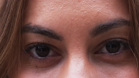 focused and determined woman looking ahead, close-up of her eyes