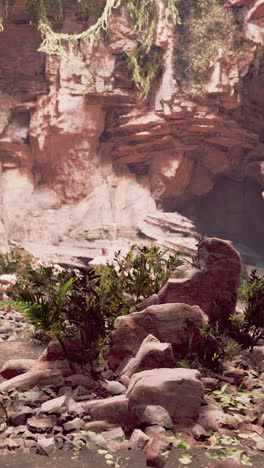 a cave entrance in a rugged mountain landscape
