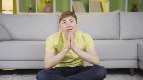 young man praying at home.