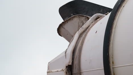 close-up of concrete mixer truck chute. ideal for construction industry documentaries and educational materials