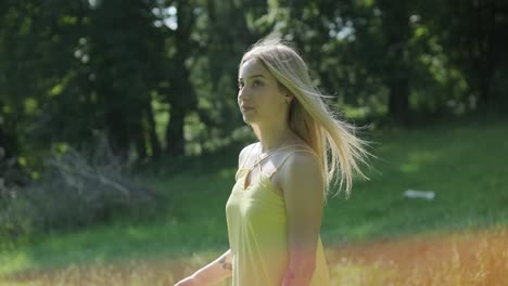 woman in yellow dress dancing gracefully in summer park