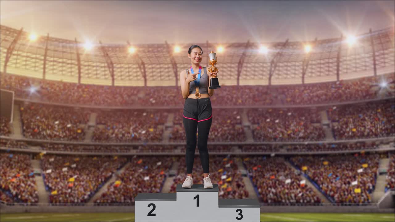 Full Body Of Asian Woman With A Gold Medal Pointing To A Gold Trophy In Her Hand Being Proud Winning As The First Winner At The Stadium