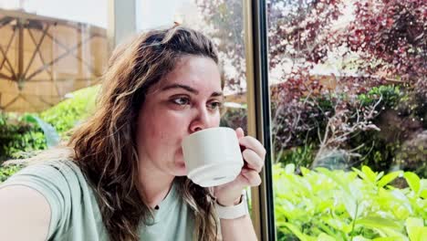 woman enjoying morning coffee on a sunny terrace