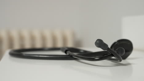 black stethoscope on a white surface