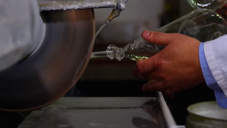 Close-up-of-male-worker-shaping-a-glassware-in-glass-factory-4k