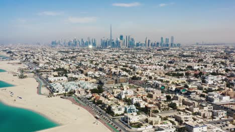 drone video of dubai city at day time, modern city concept with water and transport