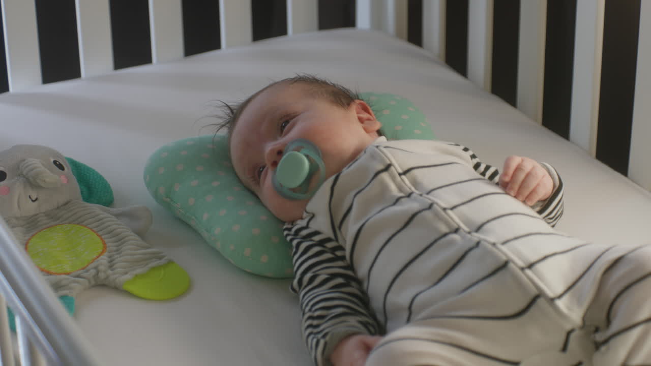 아기가 침대에서 잠을 자고 있다