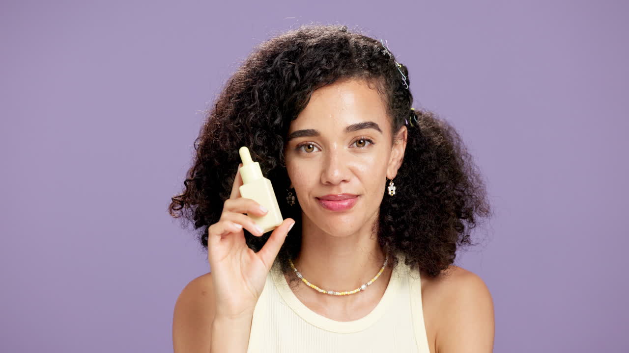 Woman holding a dropper bottle of skin care serum