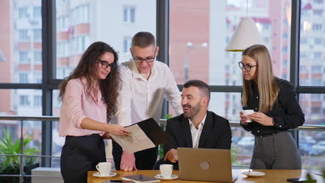 business team of colleagues having discussion in office. female employee shows her co-workers a document and people comment it.