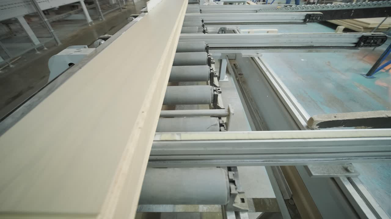 Wood Planks Moving on an Automated Conveyor Belt in a Factory