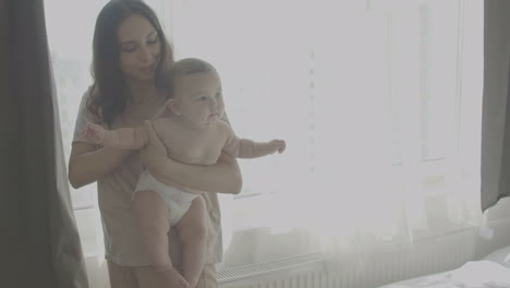 Happy-Mom-With-Her-Cute-Baby-In-Her-Arms