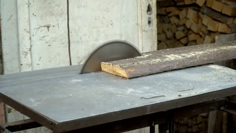 circular saw. the wizard cuts a wooden board on a circular saw. close-up.