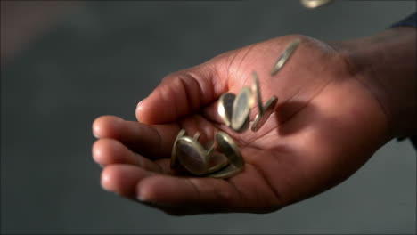 man catching falling coins in hand