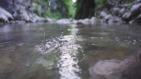 hand comes out of stream water. slow motion.