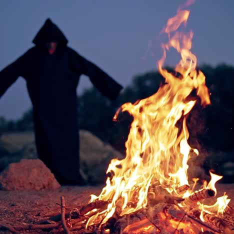monk pray at the campfire