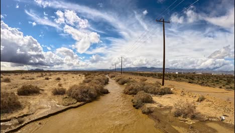 cache creek in the mojave desert flowing with water after a deluge of rain - aerial flyover