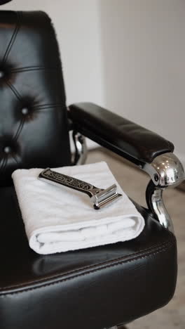 barber chair with razor and towel