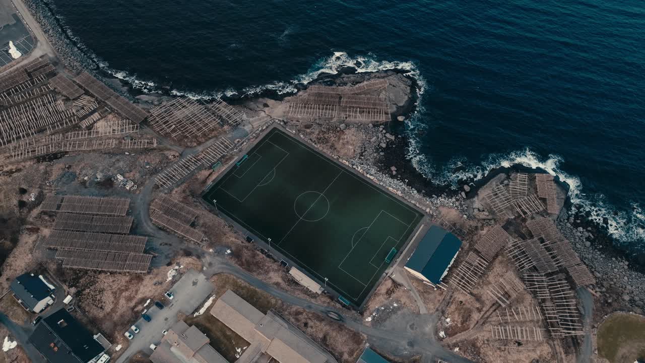 Henningsvær Football Field, Lofoten, Norway - An Aerial View of a Football (Soccer) Field Situated Right Next to the Ocean - Aerial Descend Shot